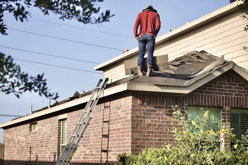 Professional roofer working on a residential roof in Hidden Palms
